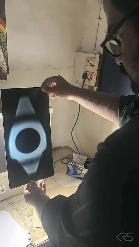 KRS technician reviewing a radiographic testing (RT) film of a fabricated component