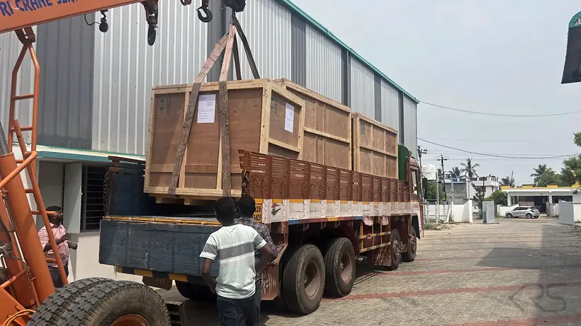 Wooden crates with KRS machines secured on a truck outside the KRS facility