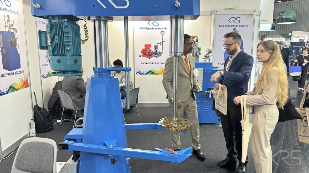 KRS DISPERMAHLTECHNIK team presenting a High Speed Disperser to visitors at ECS 2025