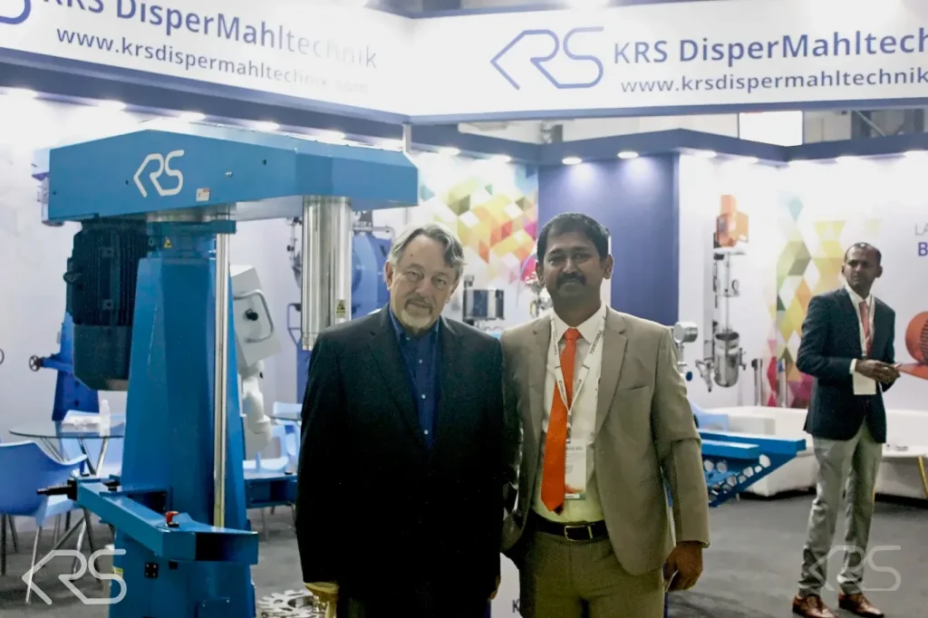 KRS DISPERMAHLTECHNIK team on the KRS DISPERMAHLTECHNIK stand at ECS 2025 beside a High Speed Disperser
